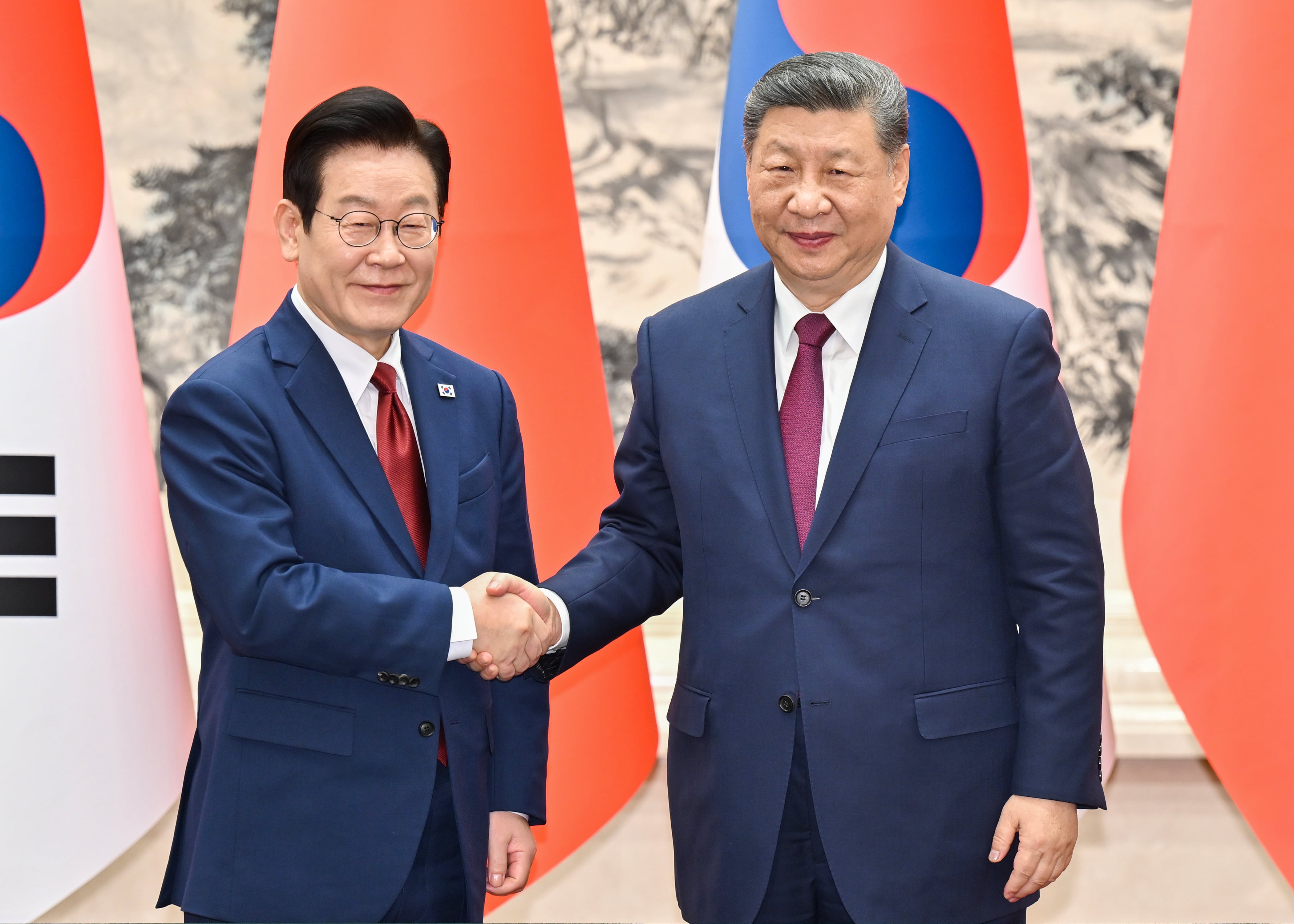 El presidente surcoreano Lee Jae Myung, izquierda, de visita en Beijing, estrecha la mano del líder chino Xi Jinping antes de su reunión bilateral en el Gran Palacio del Pueblo, en Beijing, el lunes 5 de enero de 2026 (Associated Press)