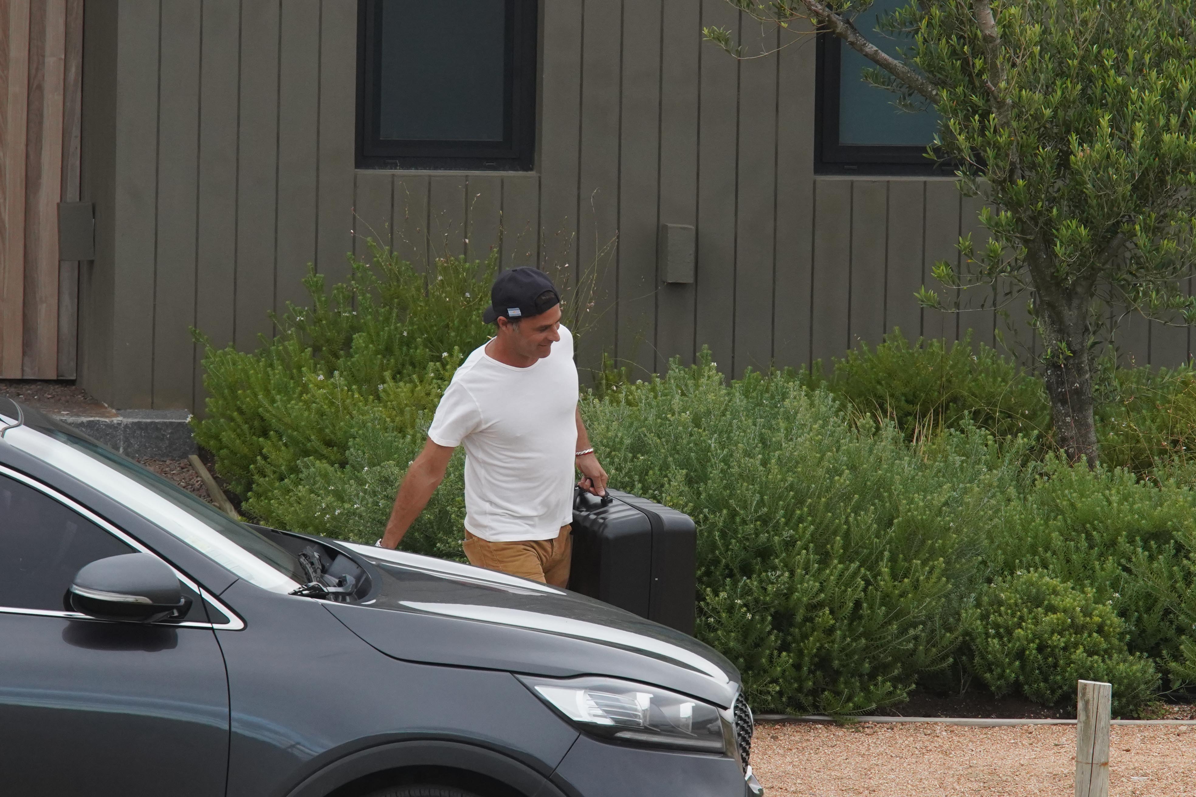 Martín Pepa llevando una de sus valijas al auto, antes de retirarse