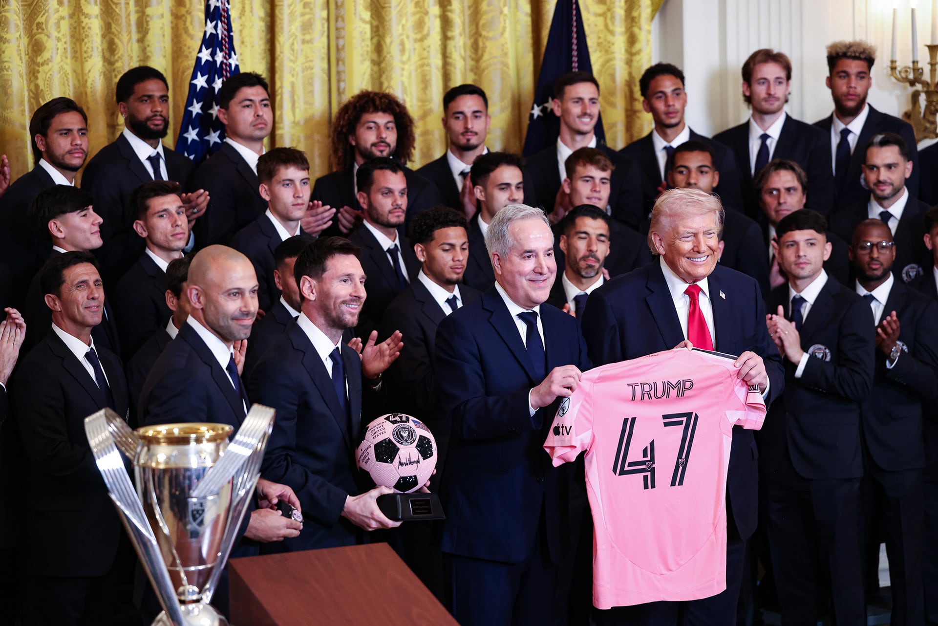 Lionel Messi, holding the ball, and Jorge Mas, owner of Inter Miami CF, present US President Donald Trump with a jersey during an event at the White House in Washington, DC on Thursday, March 5, 2026.