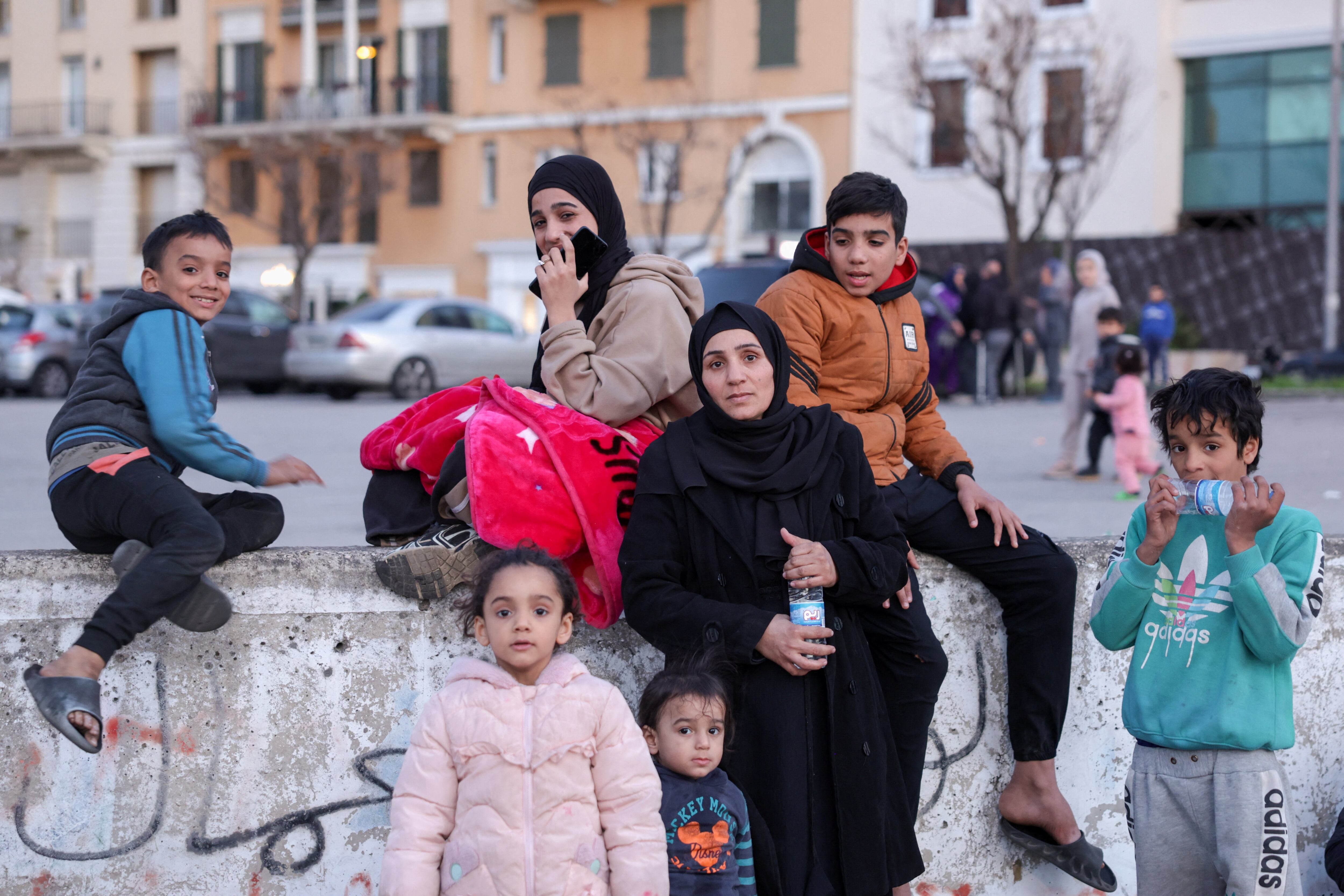 Una mujer con niños entre desplazados del sur de Beirut reunidos en la Plaza de los Mártires, el 5 de marzo de 2026. UNICEF informó que 84 de los fallecidos desde el inicio de los ataques eran niños. (REUTERS/Khalil Ashawi)