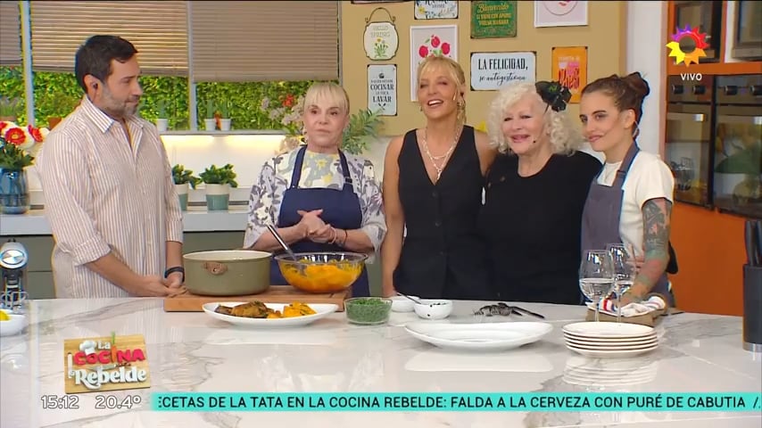Claudia Villafañe participa junto al elenco en el programa de televisión La cocina rebelde frente a varios platos preparados.