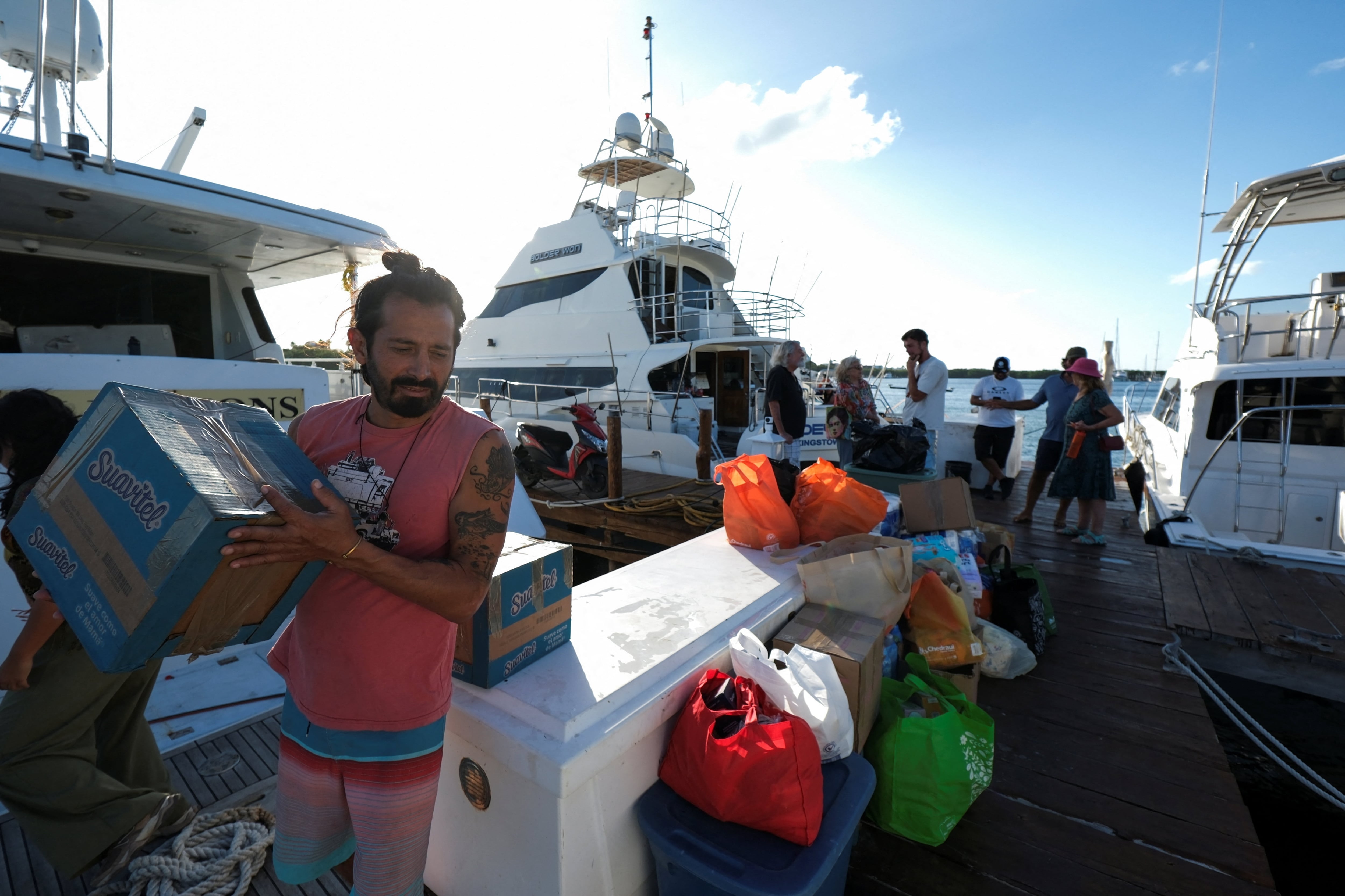 Activists participating in the Nuestra America Convoy flotilla load a boat with humanitarian aid for Cuba before setting sail from Isla Mujeres, in Quintana Roo state, Mexico, March 20, 2026. REUTERS/Paola Chiomante
